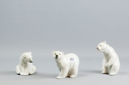 A Lladro group of three individual polar bear cubs in different poses