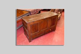 An antique oak dower chest having three square front fielded panels, fielded end panels and two base