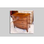 A 19th Century bow front chest of two long and two short drawers with brass ring handles on