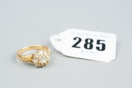 An eighteen carat gold diamond cluster ring, the centre diamond of 0.4 carat visual estimate with