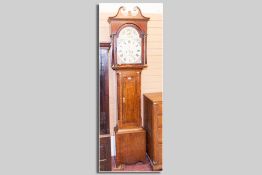 A 19th Century oak longcase clock, the arched hood with a circular painted dial, eight day