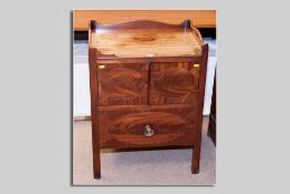 A William IV mahogany night cabinet having shaped and pierced back and side rails, two opening top