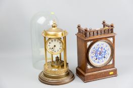 An early 20th Century brass torsion clock set within a pillared rotundo type frame with brass
