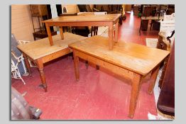 An oblong pine farmhouse table with drawer to one end, a similar table with two side drawers and a