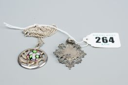 A silver neck chain with a circular silver leaf pendant with millefiori circular panel, 15.5 grms