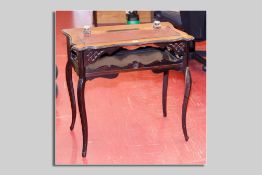An Edwardian mahogany lady's desk, the top having a narrow leatherette panel with twin ink bottles