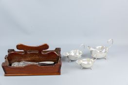 A graduated set of three electroplated sauce boats, all with shell and hoof supports and a