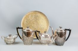 A small circular galleried electroplated tray, worn to the base metal with a four piece tea and