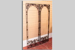 A pair of painted cast iron floral and scroll decorated garden arches, 180 x 62 cms