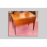 An early 19th Century mahogany drop leaf Pembroke table with opening end drawer and square tapered