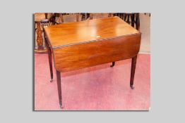 An early 19th Century mahogany drop leaf Pembroke table with opening end drawer and square tapered