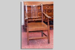 An antique oak farmhouse style elbow chair