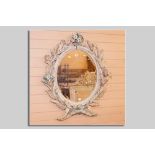 An oval painted pine bevelled wall mirror, the frame decorated all round with corn sheaves,