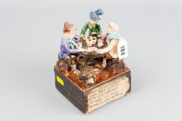 A Will Young Widecombe pottery figural group of card playing gents, 'Widecombe Fair Verse' to the