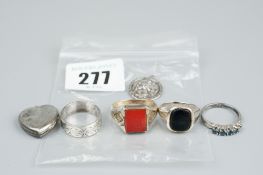 A parcel of four silver rings, 15.5 grms, a silver locket and a silver St Christopher style pendant,