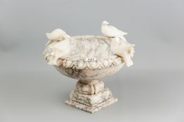 An Italian veined alabaster bird bath with carved egg and dart rim surmounted with four doves on a