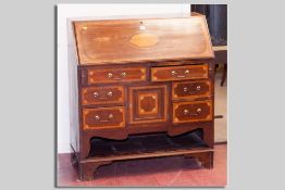 An Edwardian mahogany and inlaid fall front bureau with Sheraton fan corners and central shell inlay
