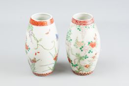 A near pair of Chinese export ovoid form vases with iron red decorated rim and foot, white