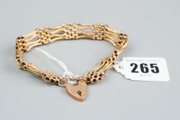 A nine carat gold four bar gate bracelet of shaped bars, each with ten oval small links and with
