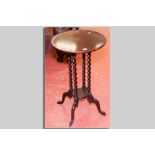 A circular tray top mahogany side table with four barley twist supports and lower central tray on