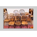 A set of four (three plus one carver) elm Windsor chairs with spindle and Celtic cross backs, a