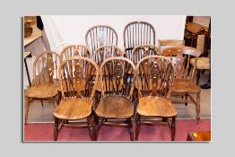 A set of four (three plus one carver) elm Windsor chairs with spindle and Celtic cross backs, a