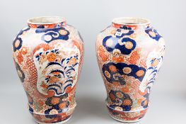 An impressive pair of Meiji period Japanese Imari jars/vases, the bulbous body decorated in a