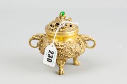 A cast gilt metal sensor and cover with mask and dragon decoration on lion mask and paw feet, the