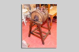 A compact barrel shaped end over end butter churn on a pitch pine stand by Hathaway