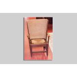 A neat oak framed Orkney style wing chair having scrolled wooden arms, a woven back and a drop-in