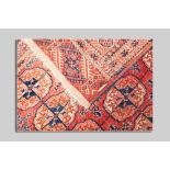 A red and blue Turkoman rug, 242 x 155 cms, having a five row border and a centre arrangement of