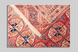 A red and blue Turkoman rug, 242 x 155 cms, having a five row border and a centre arrangement of