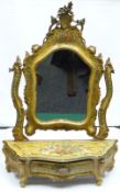 A Venetian toilet-mirror in the Rococo style having a bombe-shaped drawer base and shield shaped