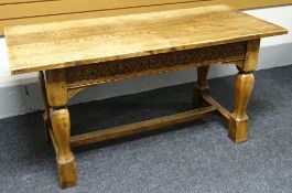 An English joined-oak refectory table, having lunette carved frieze and baluster supports to an h-