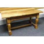 An English joined-oak refectory table, having lunette carved frieze and baluster supports to an h-