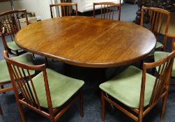 A Danish rosewood circular dining table on centre four-spoked pedestal, 119cms, extending with two