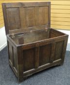 An oak blanket chest with three fielded-panels to the hinged top and front, on stile-feet, circa