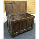 An oak blanket chest with three fielded-panels to the hinged top and front, on stile-feet, circa