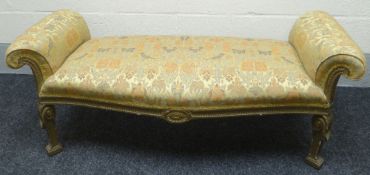 A gilt wood and carved serpentine-fronted window seat in gold covered pictorial upholstery with