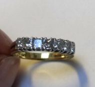 An 18ct yellow gold seven-diamond half-hoop eternity ring