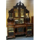 An elaborate mahogany cabinet-sideboard with arrangement of mirrored shelves, integral cabinets,