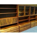 A Danish rosewood three-piece modular furniture set, comprising pair of semi-glazed bookcases with