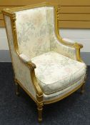 A French-empire style carved gilt-wood armchair with floral upholstery and cushion, circa 1870
