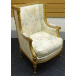 A French-empire style carved gilt-wood armchair with floral upholstery and cushion, circa 1870