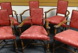 A set of six mahogany elbow chairs with curved arms, tapering upholstered seats and upholstered