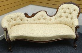 A shaped chaise longue with floral carved walnut frame and buttoned Paisley upholstery, circa