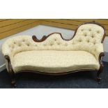 A shaped chaise longue with floral carved walnut frame and buttoned Paisley upholstery, circa