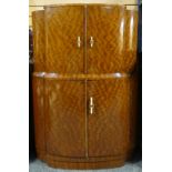 A polished mahogany two stage cocktail-cabinet of shaped form, circa 1925,  36ins wide (92cms)
