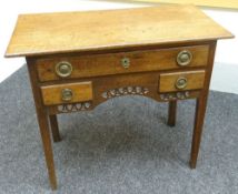 An oak low-boy with three drawer arrangement and pierce decorated apron, 35ins wide (89cms)