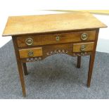 An oak low-boy with three drawer arrangement and pierce decorated apron, 35ins wide (89cms)